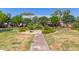 Well maintained common area with lush greenery and walking path at 1600 N Saba St # 143, Chandler, AZ 85225