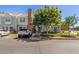 Inviting townhouse featuring a brick chimney, front yard landscaping, and off-street parking at 1600 N Saba St # 143, Chandler, AZ 85225