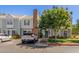 Inviting townhouse featuring a brick chimney, front yard landscaping, and off-street parking at 1600 N Saba St # 143, Chandler, AZ 85225