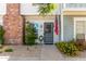 Inviting townhouse entrance with brick details, landscaping, and an American flag displayed at 1600 N Saba St # 143, Chandler, AZ 85225