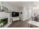 Open-concept living room featuring a fireplace, TV, and seamless flow to the dining area at 1600 N Saba St # 143, Chandler, AZ 85225