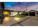 Spacious backyard featuring a covered patio and a detached garage at 1615 E Roma Ave, Phoenix, AZ 85016