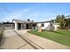 Backyard view featuring an expansive yard, patio, home, and play structure at 1615 E Roma Ave, Phoenix, AZ 85016