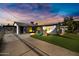 Large backyard with artificial grass, a patio, and a play structure at 1615 E Roma Ave, Phoenix, AZ 85016
