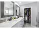 Bathroom featuring dual sinks, modern fixtures, vanity, and walk-in closet at 1615 E Roma Ave, Phoenix, AZ 85016