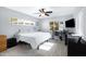 Bright bedroom features light gray walls, wood-look floors, a ceiling fan, and two windows at 1615 E Roma Ave, Phoenix, AZ 85016