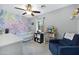 Bedroom featuring a colorful accent wall, plush carpeting, and cozy reading nook with books and toys at 1615 E Roma Ave, Phoenix, AZ 85016