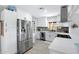 Modern kitchen features stainless steel appliances, white cabinets, and a stylish tile backsplash at 1615 E Roma Ave, Phoenix, AZ 85016