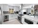 Bright kitchen boasts stainless steel appliances, modern white cabinetry, and a large island with bar seating at 1615 E Roma Ave, Phoenix, AZ 85016