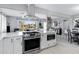 Open-concept kitchen with stainless steel appliances, an island with bar seating, and seamless access to living area at 1615 E Roma Ave, Phoenix, AZ 85016