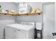 Laundry area featuring a washer, dryer, floating shelf, and a closed door at 1615 E Roma Ave, Phoenix, AZ 85016