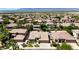 A beautiful neighborhood features lush landscaping and green yards in this overhead shot with beautiful mountain views at 1621 W Wildwood Dr, Phoenix, AZ 85045