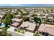 Expansive aerial view of a desert community featuring a home with a tile roof and well-kept landscaping at 1621 W Wildwood Dr, Phoenix, AZ 85045