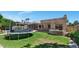 Backyard features a trampoline, patio, lush grass, privacy wall, green shrubbery and garden with the house in the background at 1621 W Wildwood Dr, Phoenix, AZ 85045