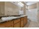 Bathroom featuring a double vanity with granite counters at 1621 W Wildwood Dr, Phoenix, AZ 85045