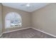 Neutral bedroom featuring an arched window with bright light at 1621 W Wildwood Dr, Phoenix, AZ 85045