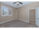 Neutral bedroom featuring a ceiling fan, neutral carpet and bright window at 1621 W Wildwood Dr, Phoenix, AZ 85045