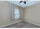 Neutral bedroom with neutral carpet featuring a ceiling fan and bright window at 1621 W Wildwood Dr, Phoenix, AZ 85045