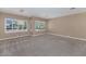 Bright bedroom showcasing neutral walls, carpet floors and sunny windows with plantation shutters at 1621 W Wildwood Dr, Phoenix, AZ 85045