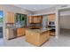 Bright kitchen with tile flooring, granite countertops, stainless steel appliances, and modern lighting at 1621 W Wildwood Dr, Phoenix, AZ 85045