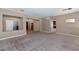 Open-concept living area with neutral walls, plush carpeting, and an open layout great for entertaining at 1621 W Wildwood Dr, Phoenix, AZ 85045