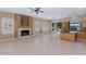 Living room area featuring tile flooring, a fireplace, and sliding glass doors for convenient outdoor access at 1621 W Wildwood Dr, Phoenix, AZ 85045
