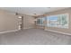 Bright and open living space with large windows, neutral walls, and plush carpeting offers style and comfort at 1621 W Wildwood Dr, Phoenix, AZ 85045