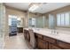 Beautiful bathroom featuring a double vanity, glass block details, and ample natural light at 1621 W Wildwood Dr, Phoenix, AZ 85045