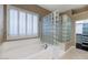 Elegant bathroom with soaking tub, glass block partition, and bright window at 1621 W Wildwood Dr, Phoenix, AZ 85045