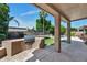This outdoor kitchen features a stainless steel grill built into an attractive stone outdoor island and patio at 1621 W Wildwood Dr, Phoenix, AZ 85045