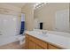 Neutral bathroom with white counters, wood cabinets and shower-tub combo at 16420 N Thompson Peak Pkwy # 1002, Scottsdale, AZ 85260