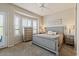 Comfortable bedroom featuring a ceiling fan, a dresser, and large windows with plantation shutters at 16420 N Thompson Peak Pkwy # 1002, Scottsdale, AZ 85260
