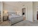 Cozy bedroom with neutral colors, plush carpet, and an ensuite bathroom with soaking tub at 16420 N Thompson Peak Pkwy # 1002, Scottsdale, AZ 85260