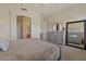 Relaxing bedroom featuring gray walls, plush carpet, and an ensuite bathroom with walk-in shower at 16420 N Thompson Peak Pkwy # 1002, Scottsdale, AZ 85260