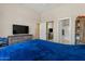 Bedroom featuring carpet, a ceiling fan, a mounted television, and access to the ensuite bathroom at 16420 N Thompson Peak Pkwy # 1002, Scottsdale, AZ 85260