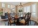 Bright dining area with a wooden table, chandelier, and views of the lush exterior at 16420 N Thompson Peak Pkwy # 1002, Scottsdale, AZ 85260