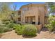 Multi-story home with a balcony and patio surrounded by desert landscaping at 16420 N Thompson Peak Pkwy # 1002, Scottsdale, AZ 85260