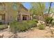 Multi-story home with a patio surrounded by desert landscaping at 16420 N Thompson Peak Pkwy # 1002, Scottsdale, AZ 85260