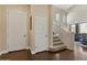 Bright foyer with high ceilings, hardwood floors, a staircase, and front door at 16420 N Thompson Peak Pkwy # 1002, Scottsdale, AZ 85260