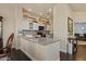 Kitchen island with granite countertops and sleek white cabinetry at 16420 N Thompson Peak Pkwy # 1002, Scottsdale, AZ 85260