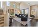 Spacious living room featuring hardwood floors, high ceilings, and a cozy fireplace at 16420 N Thompson Peak Pkwy # 1002, Scottsdale, AZ 85260