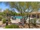 Community swimming pool surrounded by lounge chairs and desert landscaping at 16420 N Thompson Peak Pkwy # 1002, Scottsdale, AZ 85260