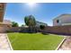 Spacious artificial turf backyard surrounded by block wall at 16527 W Ironwood St, Surprise, AZ 85388