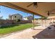 Covered patio with spacious artificial turf backyard and block wall at 16527 W Ironwood St, Surprise, AZ 85388