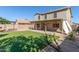 Large artificial turf backyard with covered patio and block wall at 16527 W Ironwood St, Surprise, AZ 85388