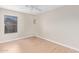 Bright bedroom with wood-look floors and natural light from a window at 16527 W Ironwood St, Surprise, AZ 85388