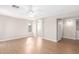Spacious bedroom with wood-style floors, ceiling fan and ensuite bathroom, offering a private retreat at 16527 W Ironwood St, Surprise, AZ 85388