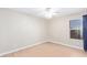 Neutral bedroom with light wood-look flooring, ceiling fan and bright window at 16527 W Ironwood St, Surprise, AZ 85388