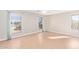 Bedroom with wood-style floors and large windows, creating a bright and inviting atmosphere at 16527 W Ironwood St, Surprise, AZ 85388