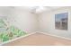 Neutral bedroom featuring bright, natural light and green accent wall at 16527 W Ironwood St, Surprise, AZ 85388